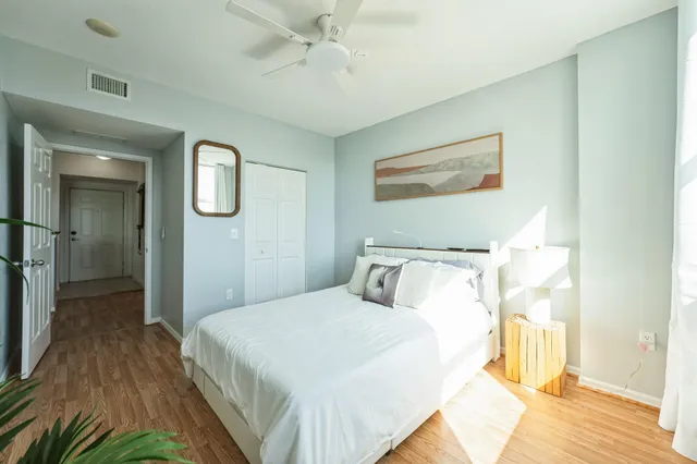 a bedroom with a bed and a chandelier