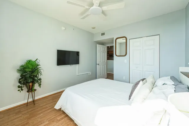 a bedroom with a bed and a flat screen tv