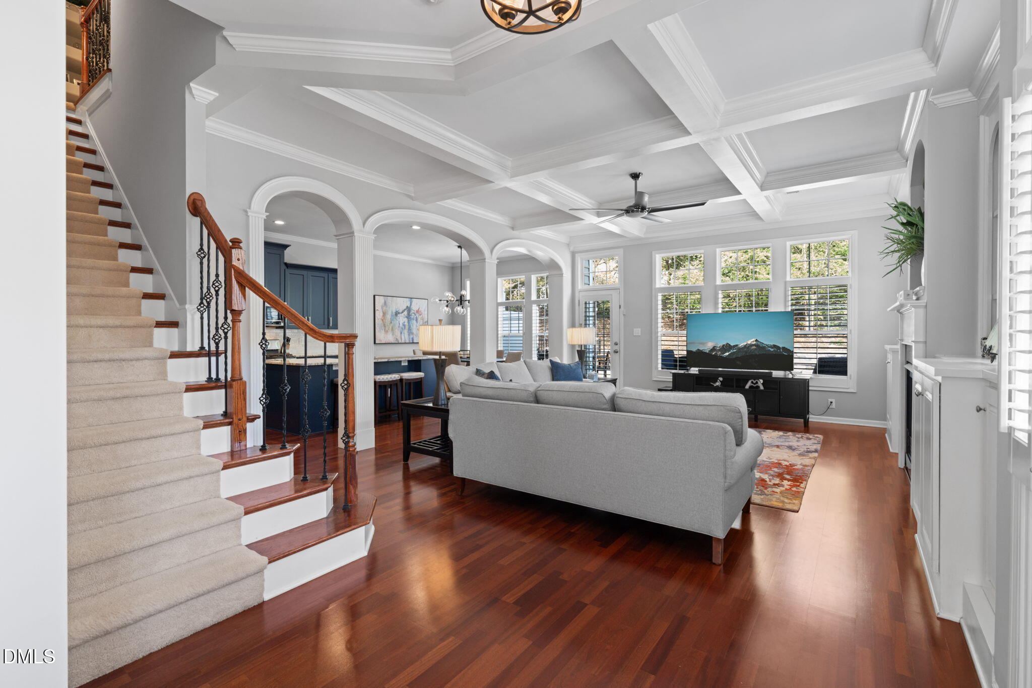 a living room with fireplace furniture and a wooden floor