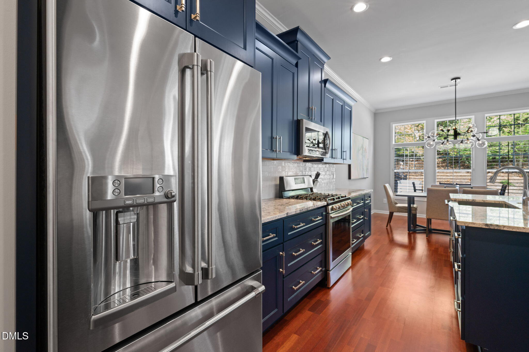 13227 Ashford Park Drive Raleigh, NC 27613 - Photo 15 of 55 a kitchen with stainless steel appliances granite countertop a refrigerator a stove top oven a sink dishwasher and cabinets with wooden floor