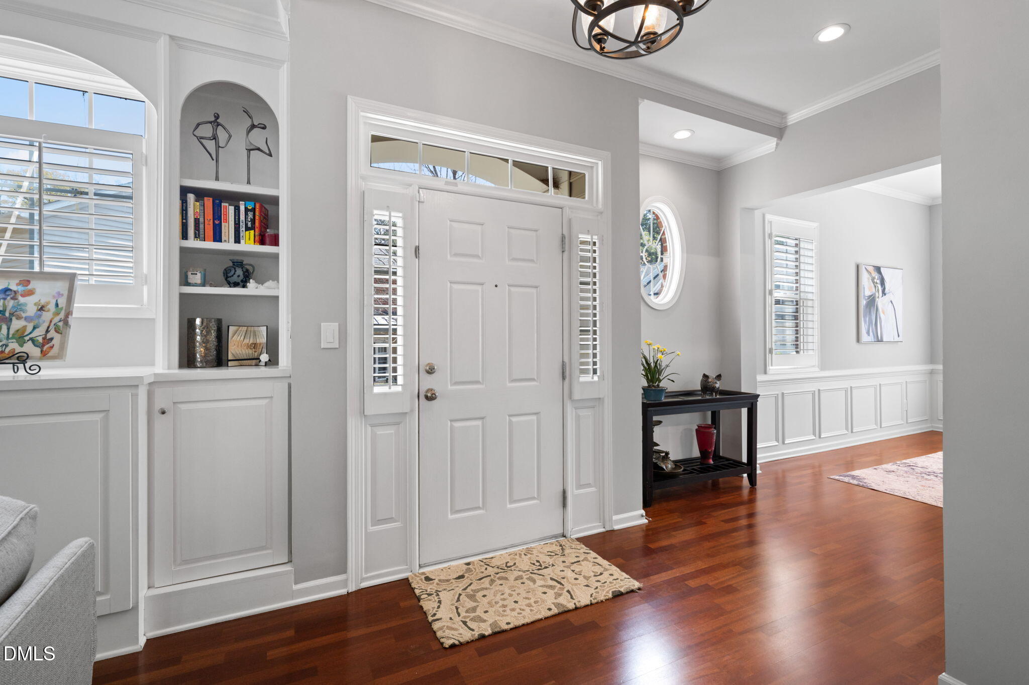 13227 Ashford Park Drive Raleigh, NC 27613 - Photo 6 of 55 a view of a hallway with wooden floor and a living room