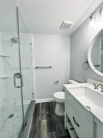 a bathroom with a sink toilet and a shower