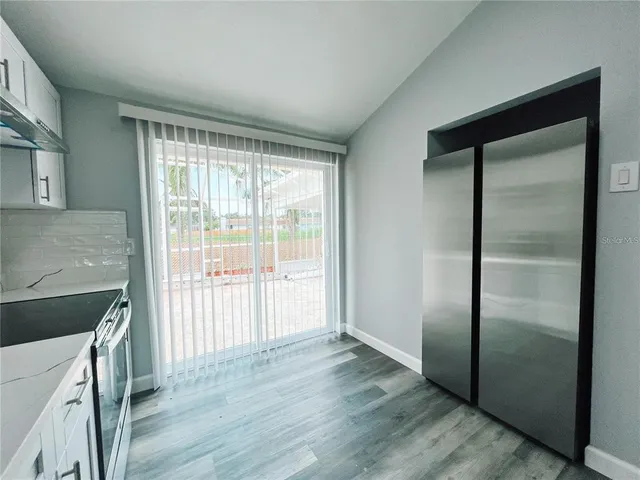 a view of a kitchen from a hallway