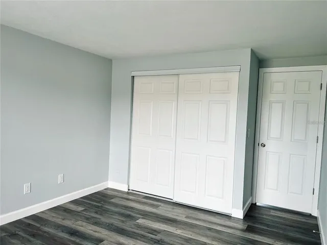 a view of an empty room and wooden floor