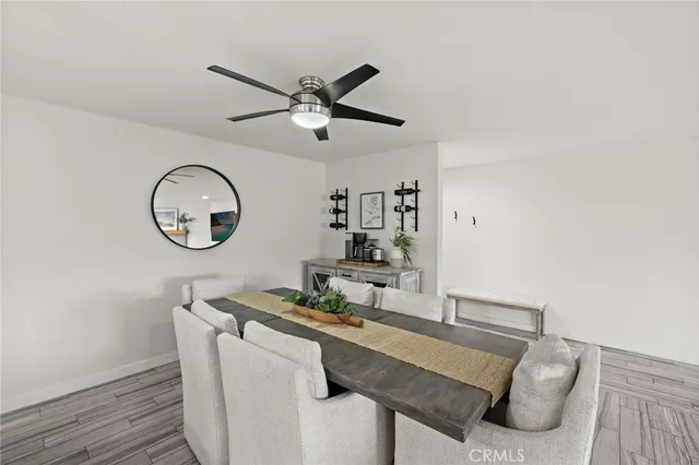 a room with a table chairs and a wooden floor