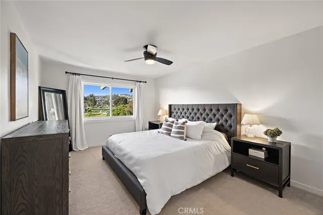 a bedroom with a large bed and a window