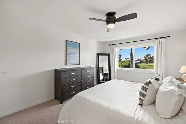 a bedroom with a bed and a painting on the wall