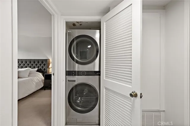 a view of a bedroom with washer and dryer
