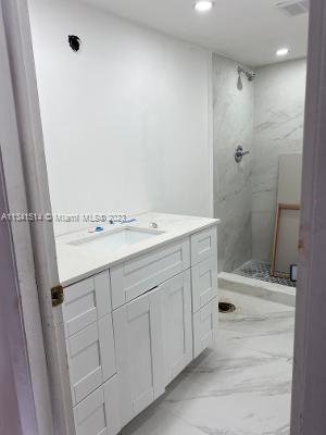 Ojus Miami, FL 33179 - Photo 13 of 18 a bathroom with a sink a toilet and shower