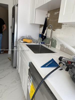 Ojus Miami, FL 33179 - Photo 9 of 18 a kitchen with a sink appliances and cabinets