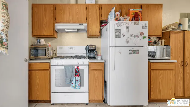 a kitchen with refrigerator and cabinets