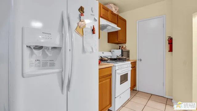 a kitchen with stainless steel appliances a refrigerator and a stove