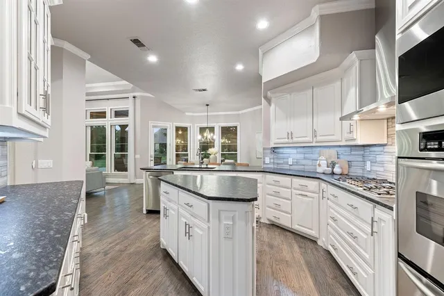 a kitchen with a sink stove and cabinets