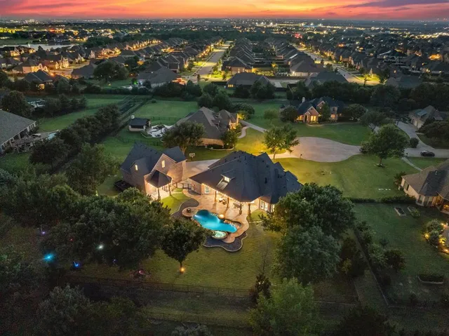 an aerial view of residential houses with outdoor space and river