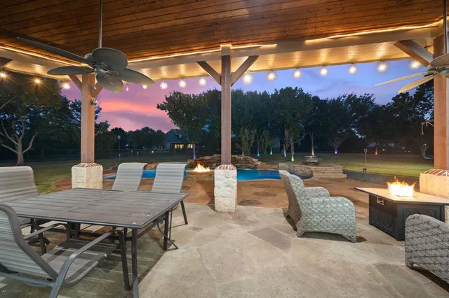 a view of a patio with a table and chairs