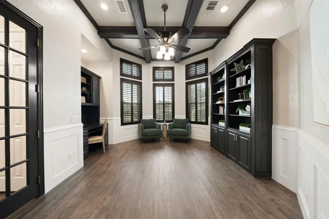 an empty room with wooden floor chandelier entryway and windows