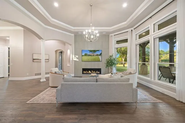 a living room with furniture and a chandelier