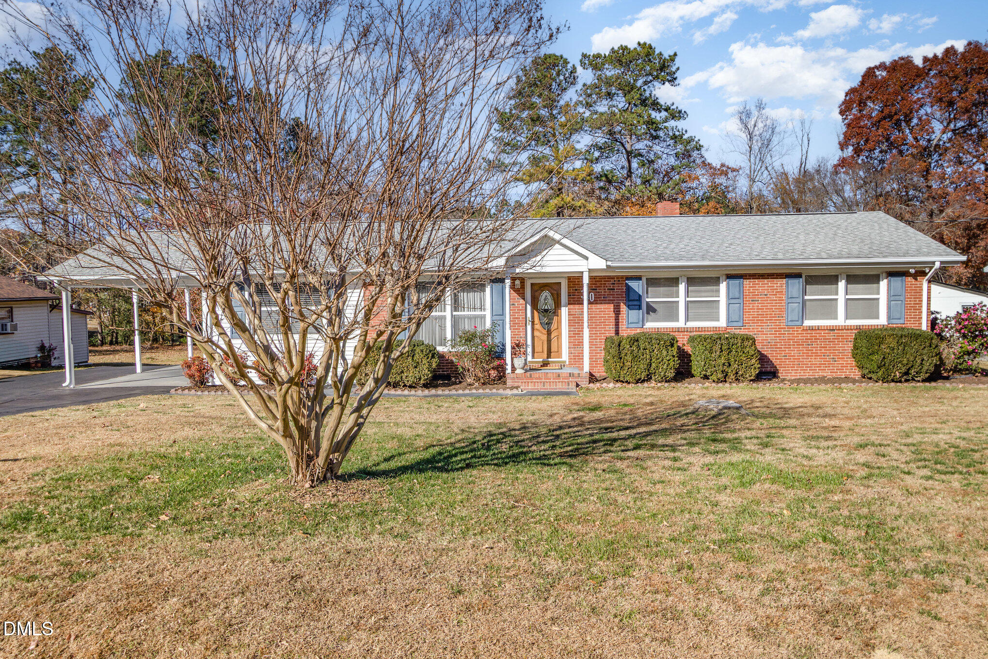 310 Mickey Circle Durham, NC 27712 - Photo 1 of 27 a front view of a house with a garden and trees