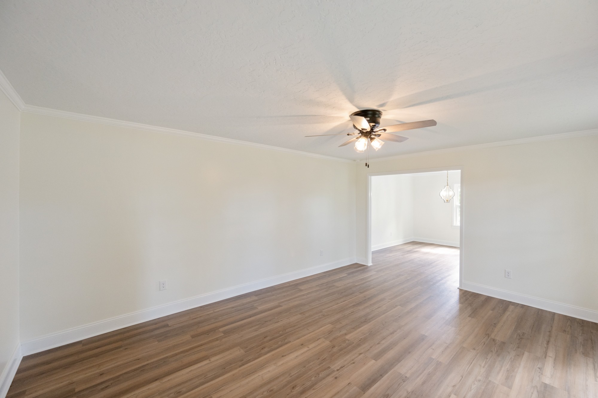 6920 Highway 192 Holladay, TN 38341 - Photo 15 of 38 an empty room with wooden floor and fan