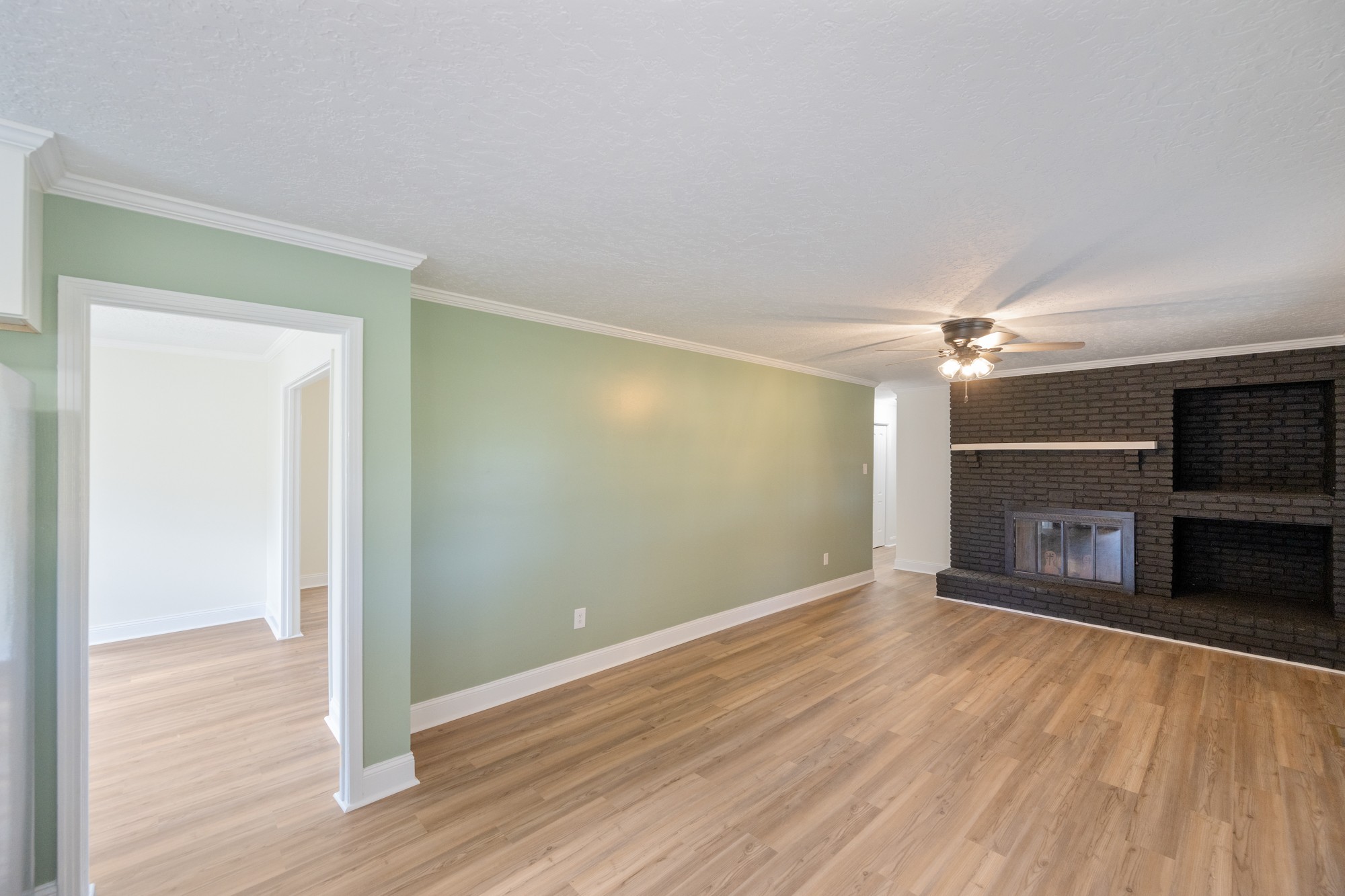 6920 Highway 192 Holladay, TN 38341 - Photo 19 of 38 a view of a room with wooden floor fireplace and a window
