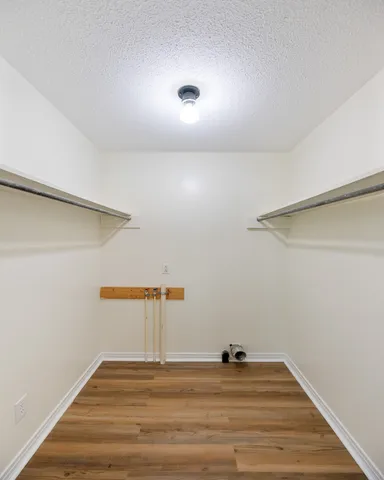 a view of a room with wooden floor
