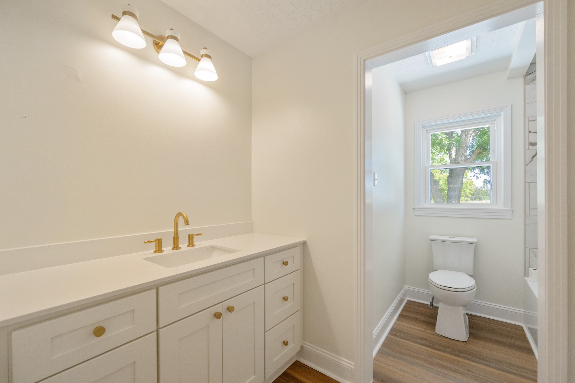 6920 Highway 192 Holladay, TN 38341 - Photo 33 of 38 a bathroom with a toilet a sink and mirror
