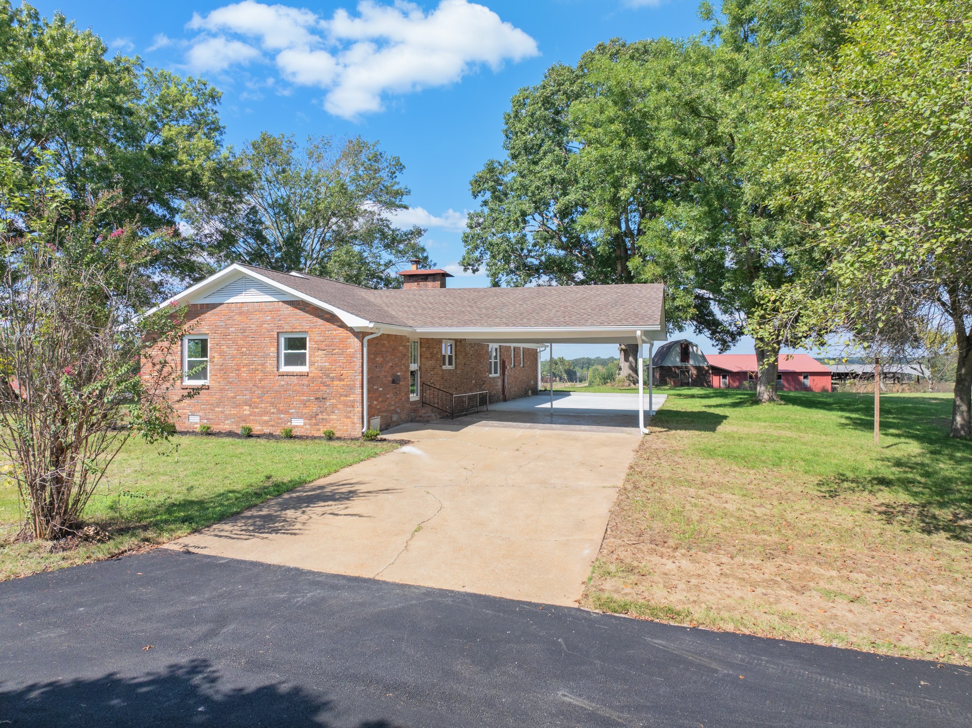 6920 Highway 192 Holladay, TN 38341 - Photo 6 of 38 a front view of a house with a yard and garage