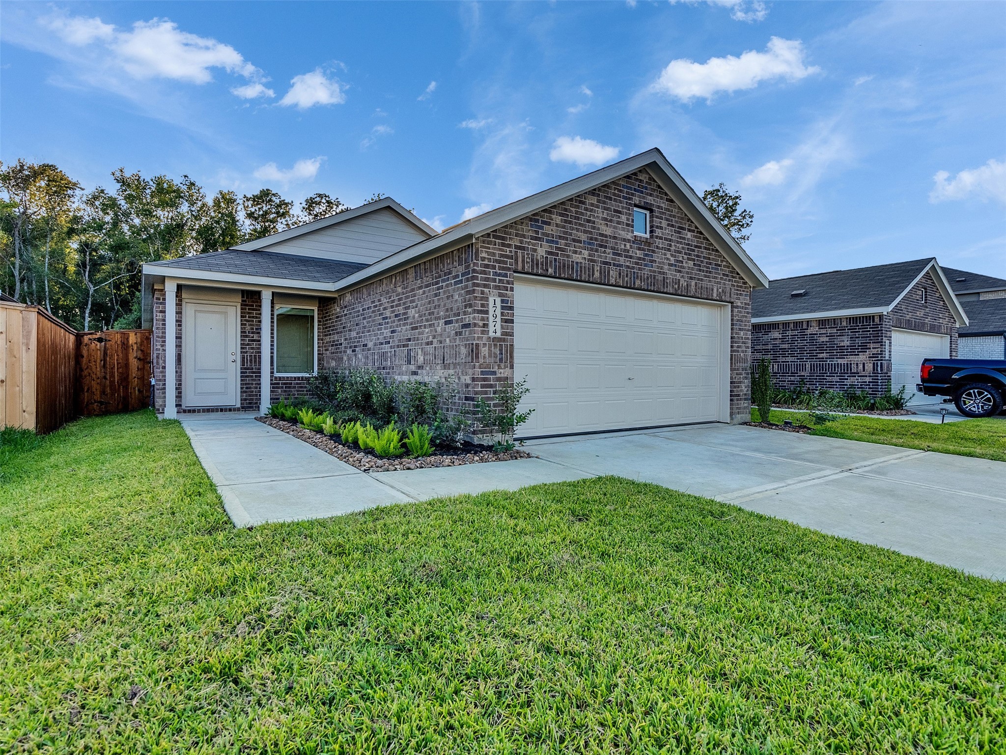 front view of a house with a yard and potted plants