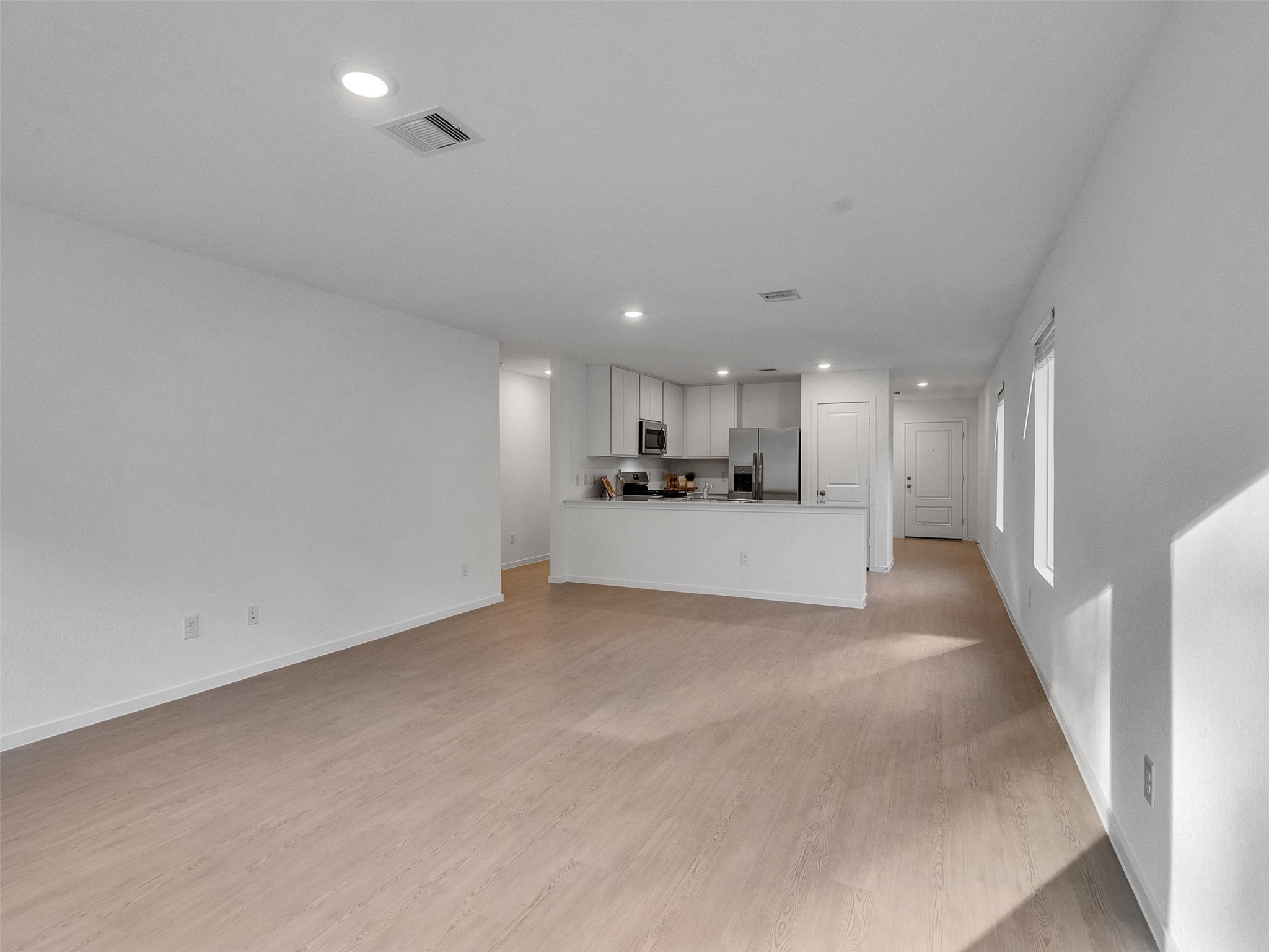 17974 Valle Cupa Lane New Caney, TX 77357 - Photo 12 of 36 a view of a kitchen with a sink and a microwave