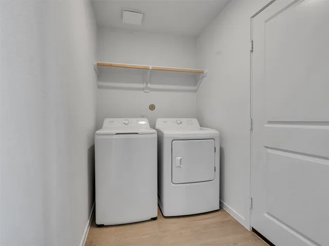 a view of a backyard with a palm tree and wooden fence