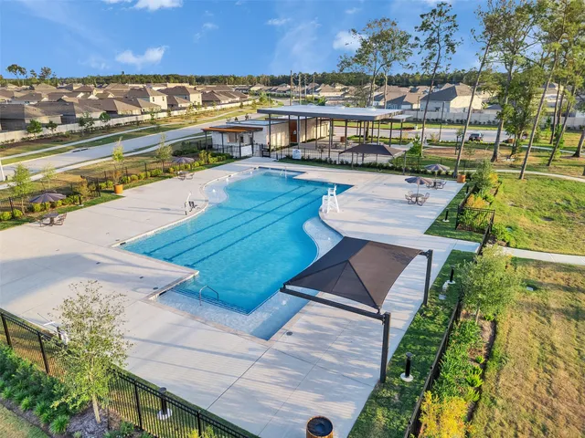 a view of swimming pool with outdoor seating and lake view