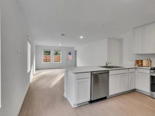 a kitchen with stainless steel appliances granite countertop a sink and cabinets