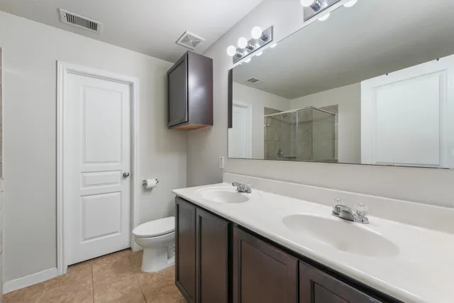 a bathroom with a sink a toilet and mirror