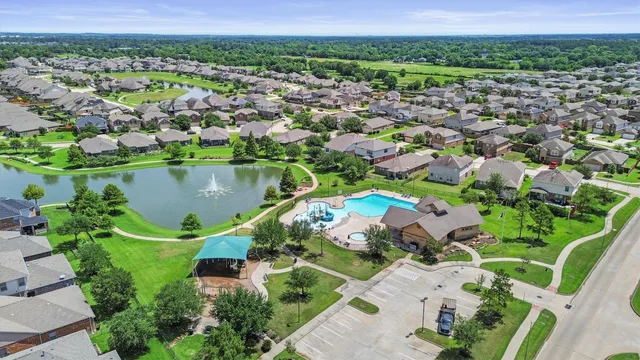 an aerial view of a house with a garden and lake view