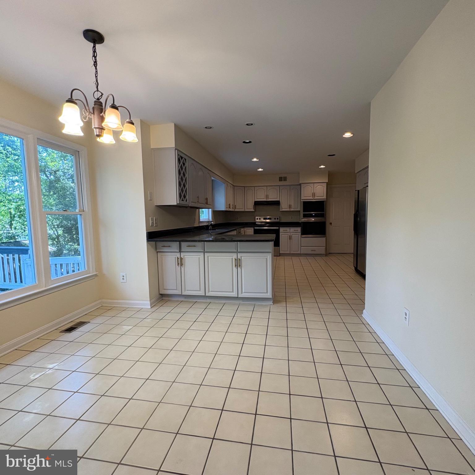 3502 Holly Road Annandale, VA 22003 - Photo 7 of 57 a large kitchen with stainless steel appliances granite countertop a stove a sink and a microwave