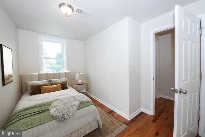 114 Brookfield Terrace Ardmore, PA 19003 - Photo 11 of 13 a bedroom with a bed and wooden floor