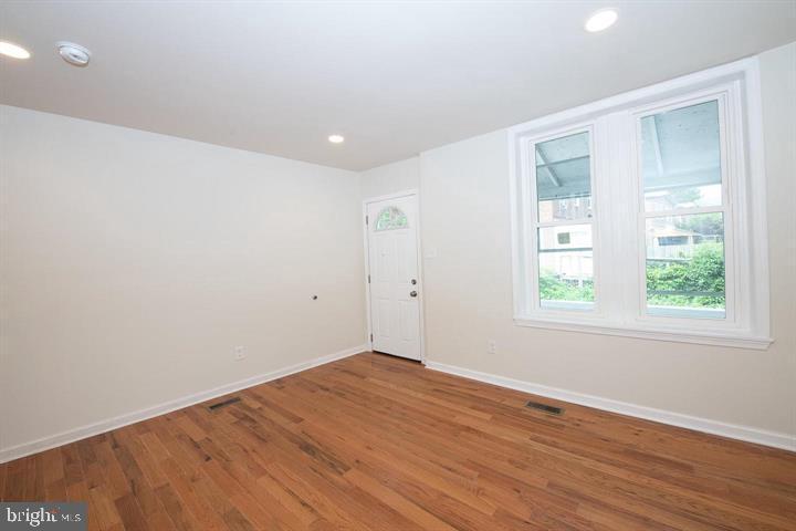 114 Brookfield Terrace Ardmore, PA 19003 - Photo 2 of 13 an empty room with wooden floor and windows