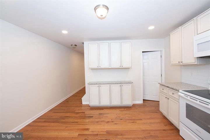 114 Brookfield Terrace Ardmore, PA 19003 - Photo 5 of 13 a view of kitchen with granite countertop cabinets and wooden floor