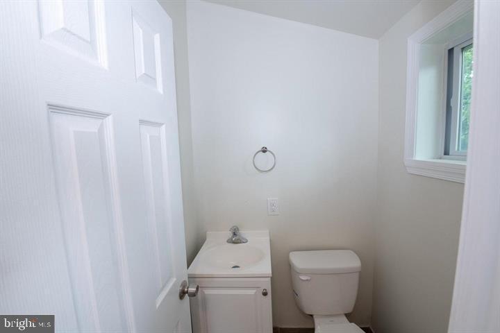 114 Brookfield Terrace Ardmore, PA 19003 - Photo 7 of 13 a white toilet sitting next to a white sink and vanity
