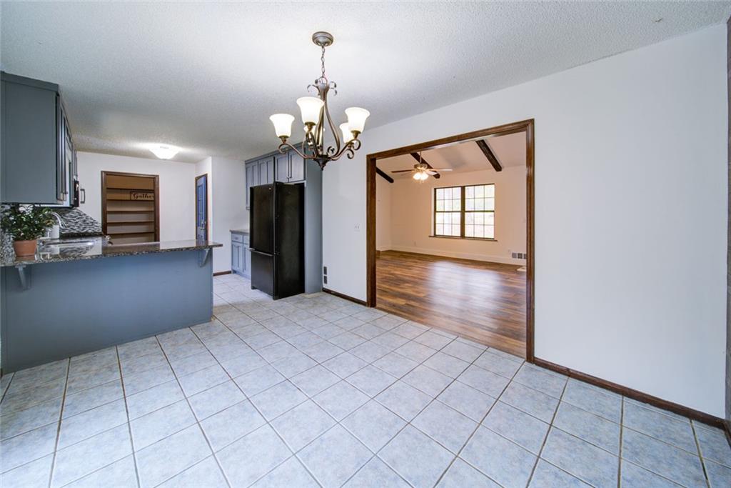 2976 Sweetwater Juno Road Dawsonville, GA 30534 - Photo 12 of 42 an empty room with chandelier and windows