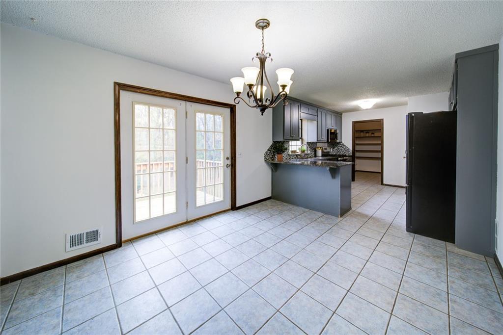 2976 Sweetwater Juno Road Dawsonville, GA 30534 - Photo 13 of 42 a view of a kitchen with fridge and dishwasher cabinets