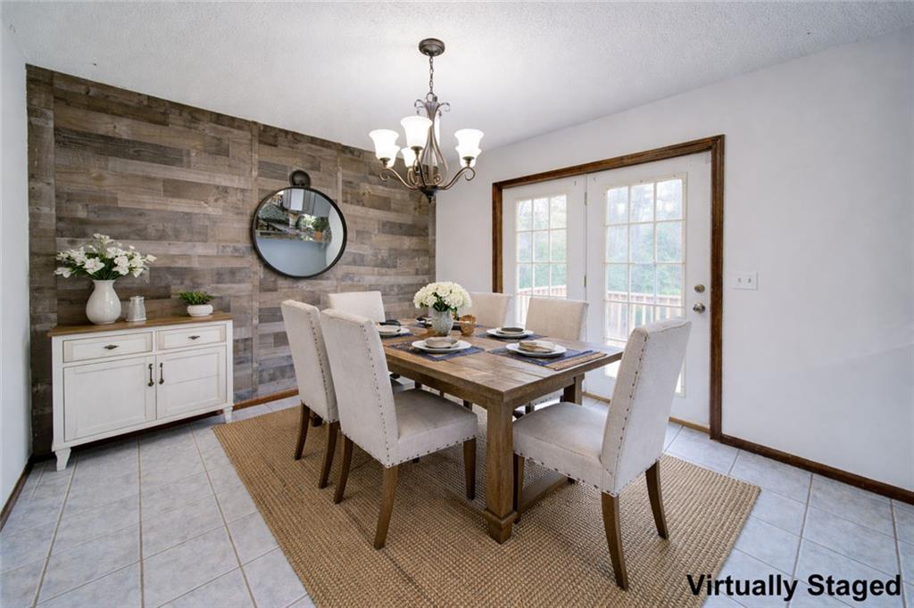 2976 Sweetwater Juno Road Dawsonville, GA 30534 - Photo 14 of 42 a view of a dining room with furniture a chandelier and wooden floor