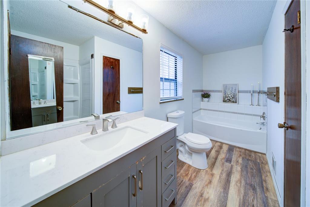 2976 Sweetwater Juno Road Dawsonville, GA 30534 - Photo 20 of 42 a bathroom with a sink a toilet and shower