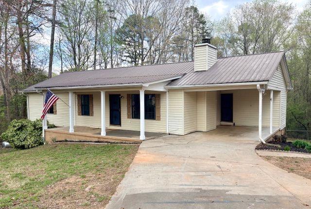 2976 Sweetwater Juno Road Dawsonville, GA 30534 - Photo 2 of 42 a front view of a house with a garden and plants