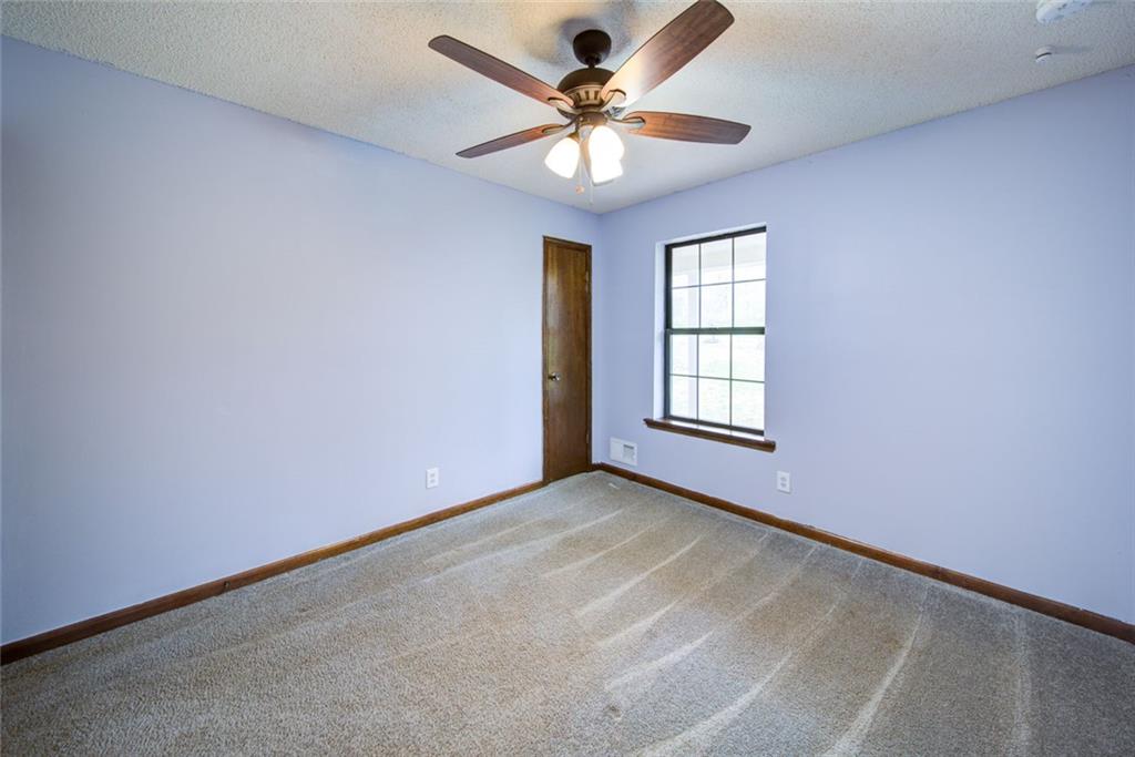 2976 Sweetwater Juno Road Dawsonville, GA 30534 - Photo 24 of 42 an empty room with windows and ceiling fan