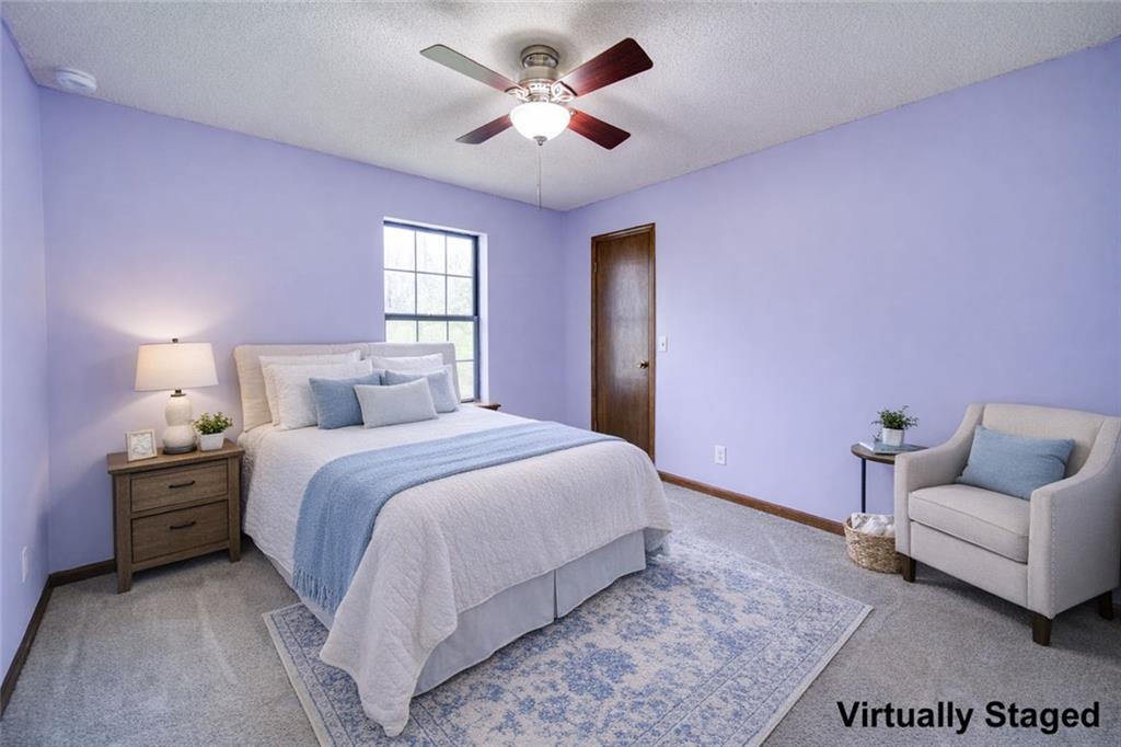 2976 Sweetwater Juno Road Dawsonville, GA 30534 - Photo 25 of 42 a bedroom with a bed and ceiling fan