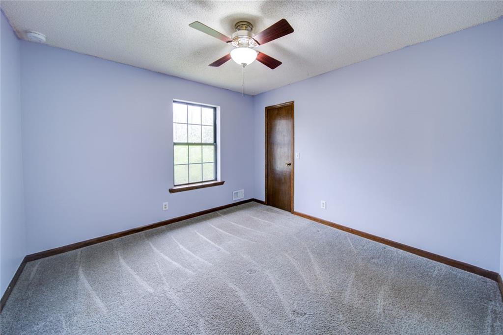 2976 Sweetwater Juno Road Dawsonville, GA 30534 - Photo 26 of 42 an empty room with windows and ceiling fan
