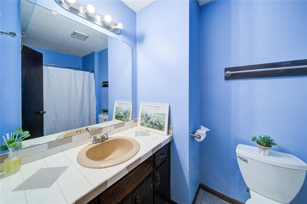 2976 Sweetwater Juno Road Dawsonville, GA 30534 - Photo 27 of 42 a bathroom with a sink vanity granite and a mirror