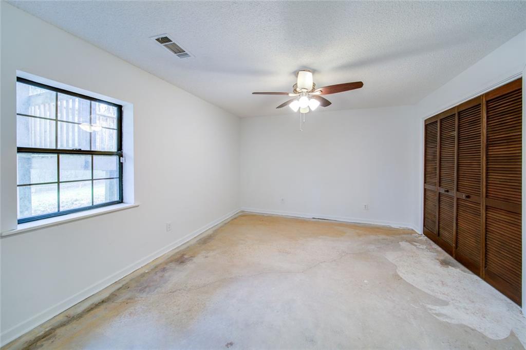2976 Sweetwater Juno Road Dawsonville, GA 30534 - Photo 32 of 42 an empty room with windows and chandelier fan