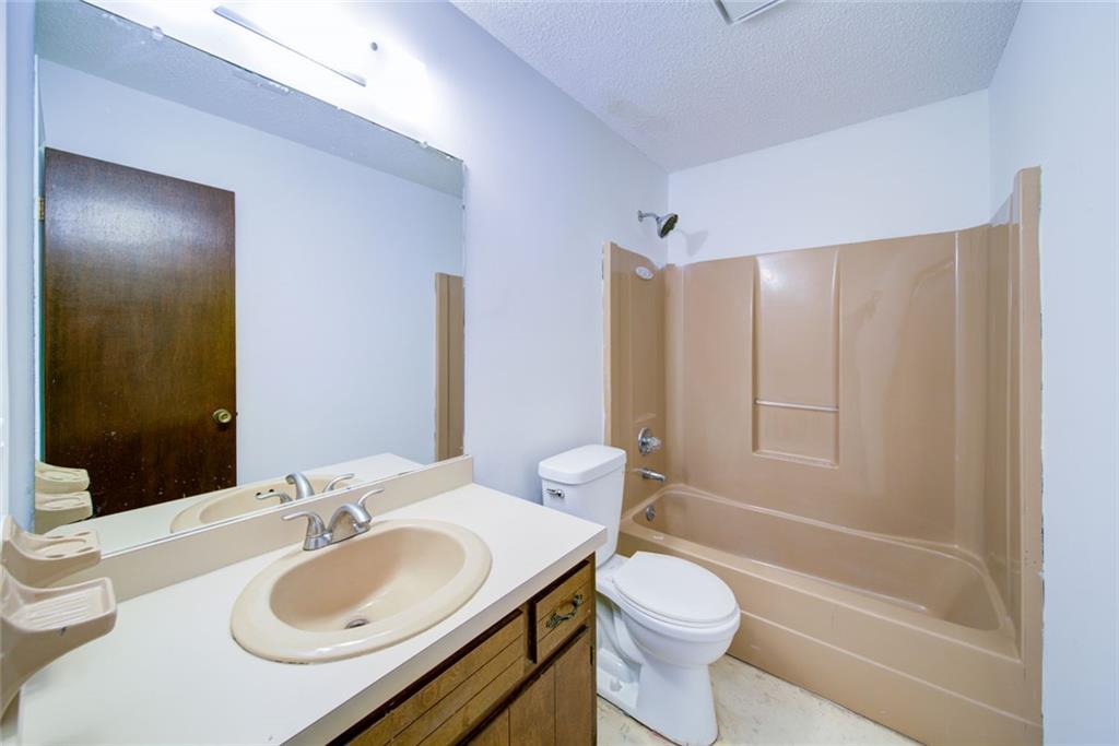 2976 Sweetwater Juno Road Dawsonville, GA 30534 - Photo 34 of 42 a bathroom with a sink toilet vanity and shower